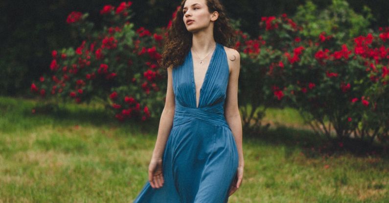 Rose Bushes - Barefoot Woman in Blue Maxi Dress Walk on Lawn