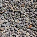 Xeriscaping - a pile of rocks sitting on top of a sidewalk