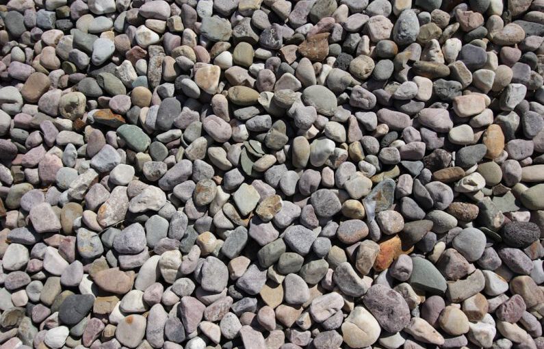 Xeriscaping - a pile of rocks sitting on top of a sidewalk