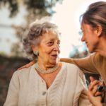 Cottage Garden - Joyful adult daughter greeting happy surprised senior mother in garden