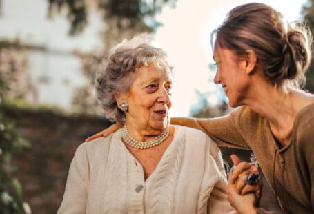 Cottage Garden - Joyful adult daughter greeting happy surprised senior mother in garden