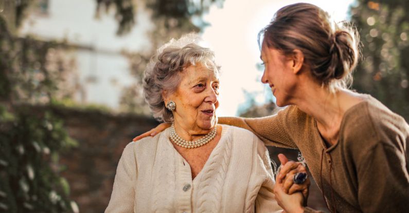 Cottage Garden - Joyful adult daughter greeting happy surprised senior mother in garden