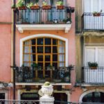 Window Boxes - a building with a balcony and a statue in front of it