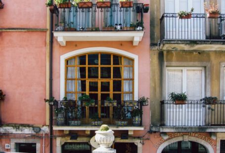 Window Boxes - a building with a balcony and a statue in front of it