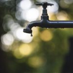 Drip Irrigation - tilt shift lens photography of black steel faucet