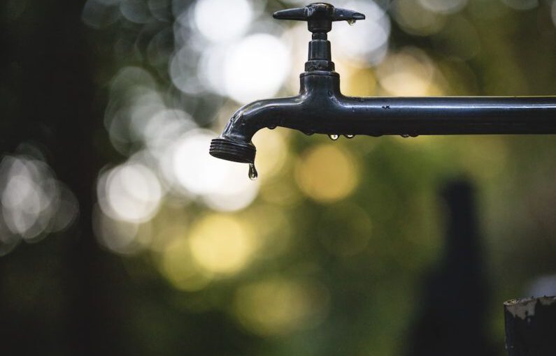 Drip Irrigation - tilt shift lens photography of black steel faucet