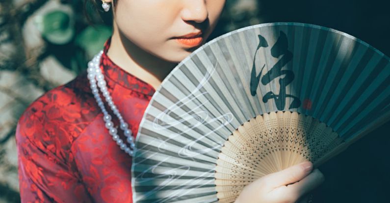 No-Till Garden - A woman in a red dress holding a fan