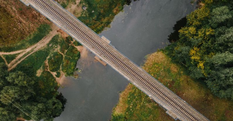 Irrigation Systems - Aerial Footage of Train Tracks over Water Canal