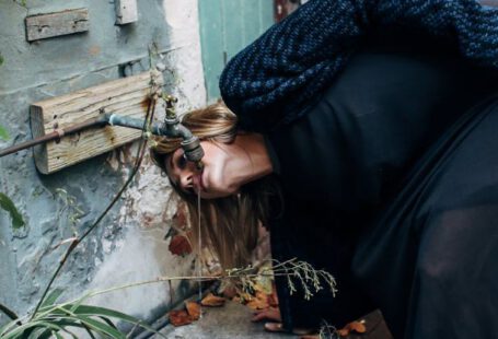 Drip Irrigation Systems - Woman drinking water from a Faucet